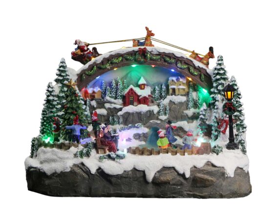 Villaggio natalizio in movimento con pattinatori, musica e led