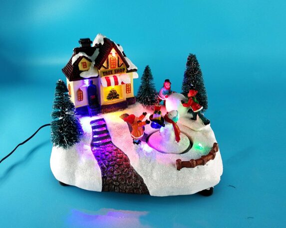 Villaggio natalizio innevato in movimento con pupazzo di neve, musica e led