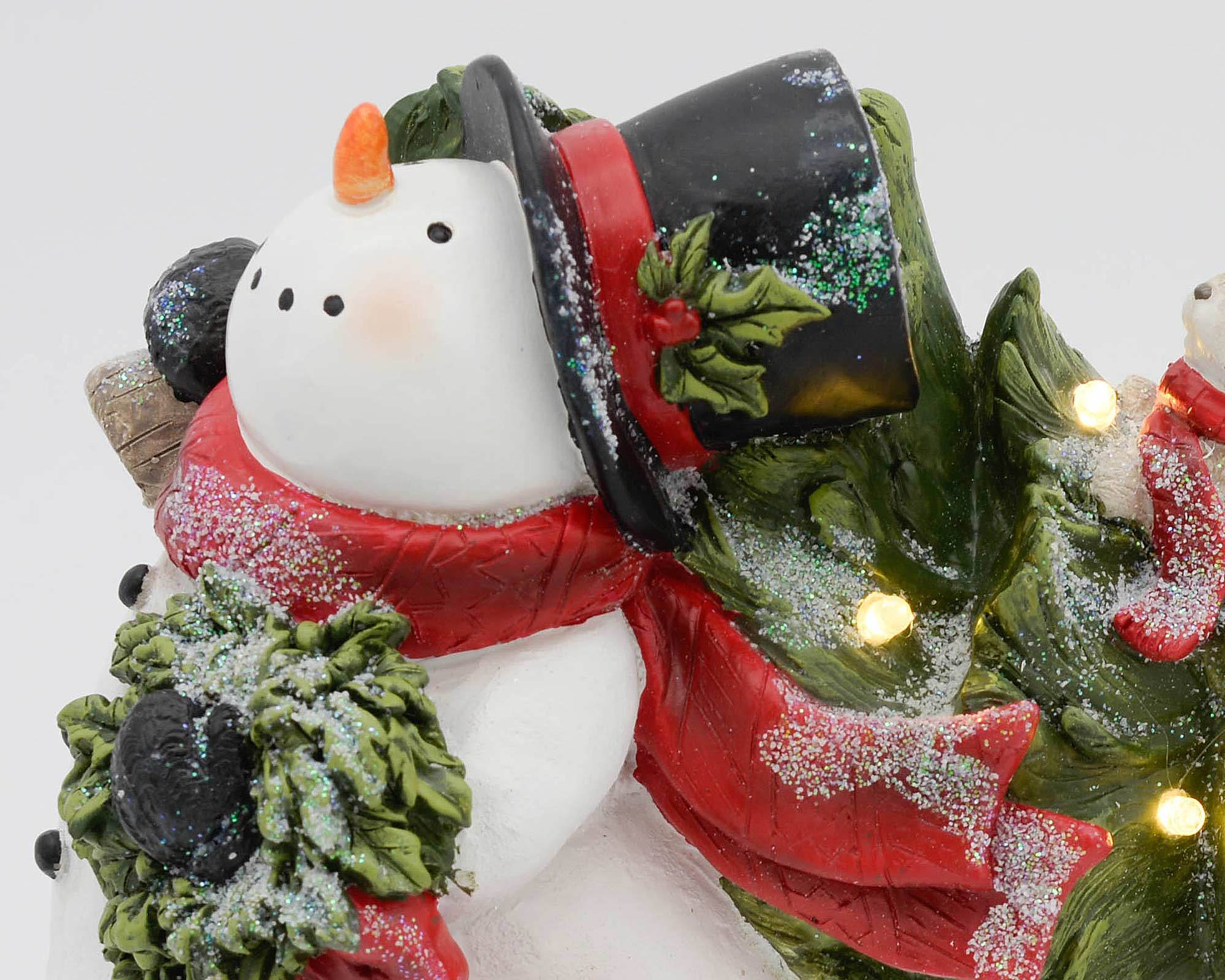 Decorazioni natalizie con due pupazzi di neve che tengono un albero di natale - immagine 2