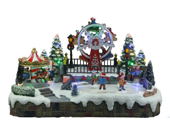 Villaggio innevato Giostre in movimento con carosello, ruota panoramica, musica e led