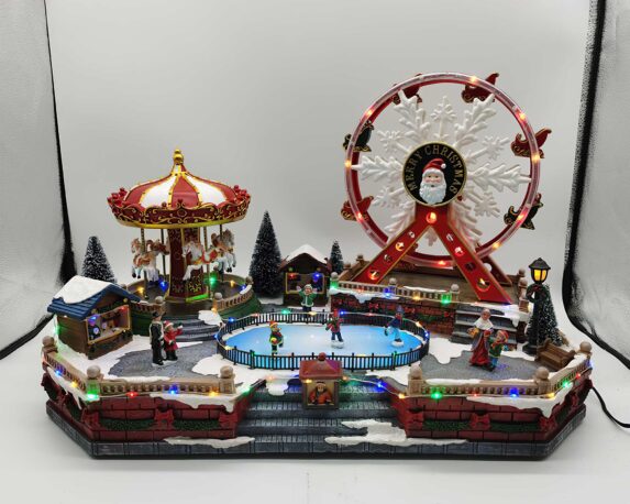 Villaggio innevato Giostre in movimento con giostra dei cavalli, ruota panoramica, musica e led