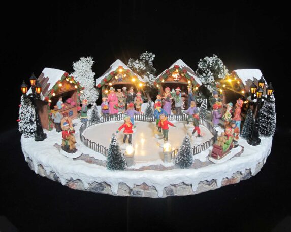 Villaggio di Natale innevato in movimento con pattinatori e led